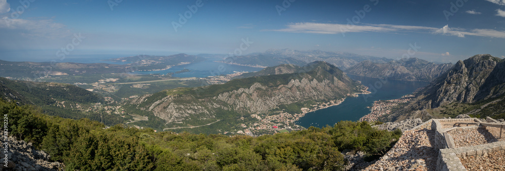 Panorama of the beautiful Kotor bay, viewed from the Lovcen national park in Montenegro on a sunny almost cloud-less day. Visible Kotor, Tivat, sea and distant mountains