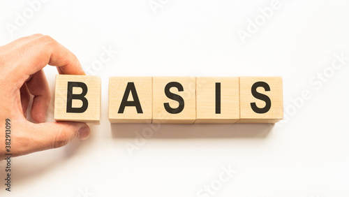 Word basis. Wooden small cubes with letters isolated on white background with copy space available. Business Concept image.