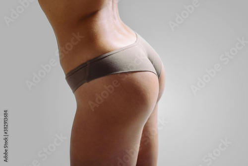 Beautiful girls buttocks in underwear. Close up photo of woman's panties. Not a perfect female body