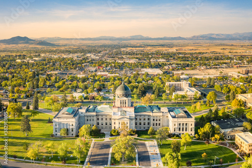 Drone view of the Montana State Capitol, in Helena, on a sunny afternoon with hazy sky caused by wildfires. The Montana State Capitol houses the Montana State Legislature. photo