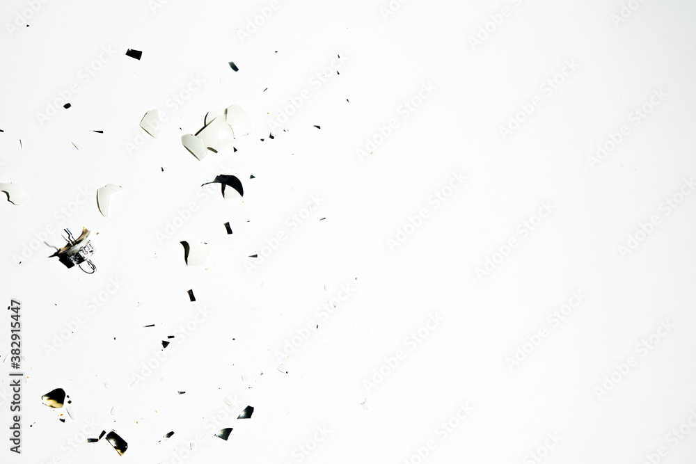 Broken pieces of a christmas balls are sprea around a clen background,top view. Broken pieces of a christmas balls are sprea around a clen background,top view.