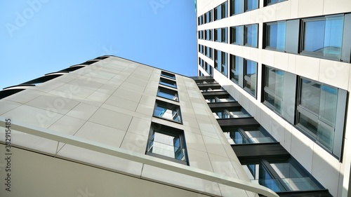 A fragment of the sandstone facade of a modern office building. Wide abstract fragment of modern building facade.