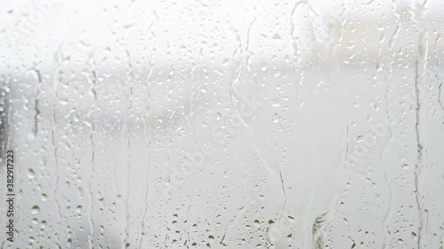 Rain pounding in front of clear glass on a cold winter day