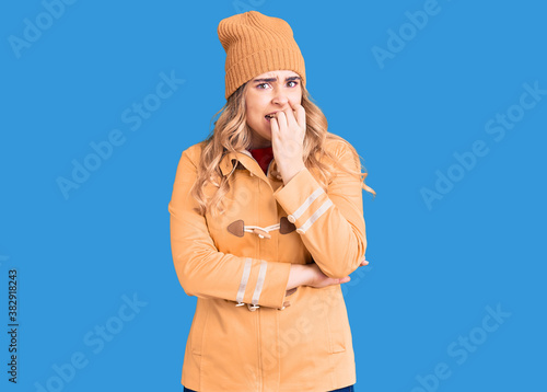 Young caucasian woman wearing casual clothes looking stressed and nervous with hands on mouth biting nails. anxiety problem.