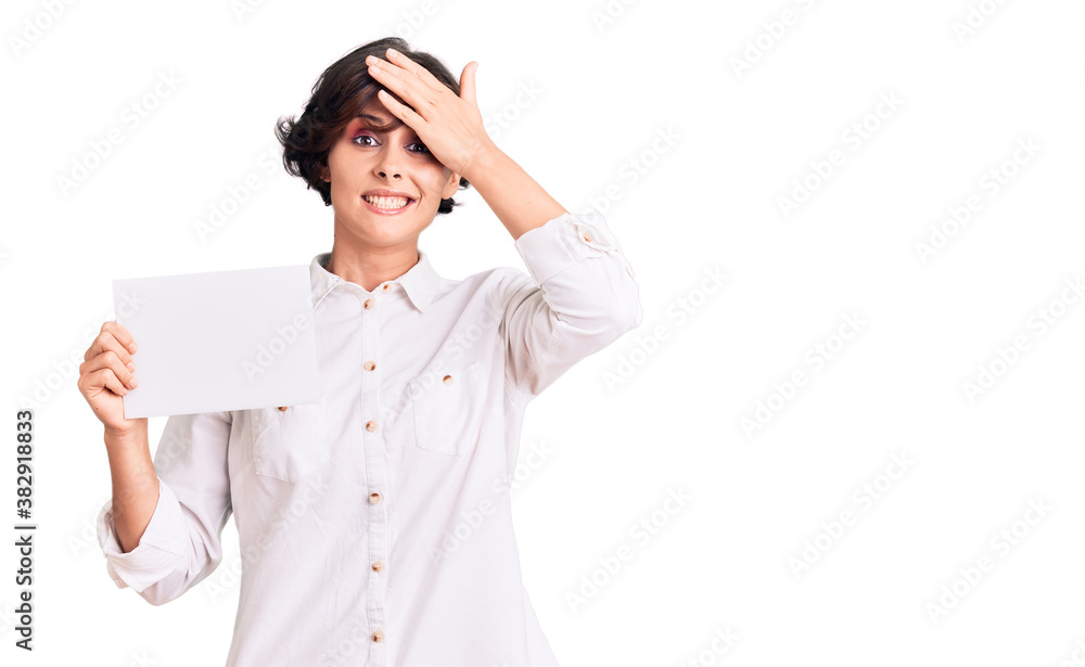 Beautiful young woman with short hair holding blank empty banner stressed and frustrated with hand on head, surprised and angry face Beautiful young woman with short hair holding blank empty banner stressed and frustrated with hand on head, surprised and angry face