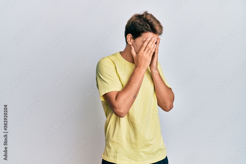 Handsome caucasian man wearing casual clothes with sad expression covering face with hands while crying. depression concept. Handsome caucasian man wearing casual clothes with sad expression covering face with hands while crying. depression concept.
