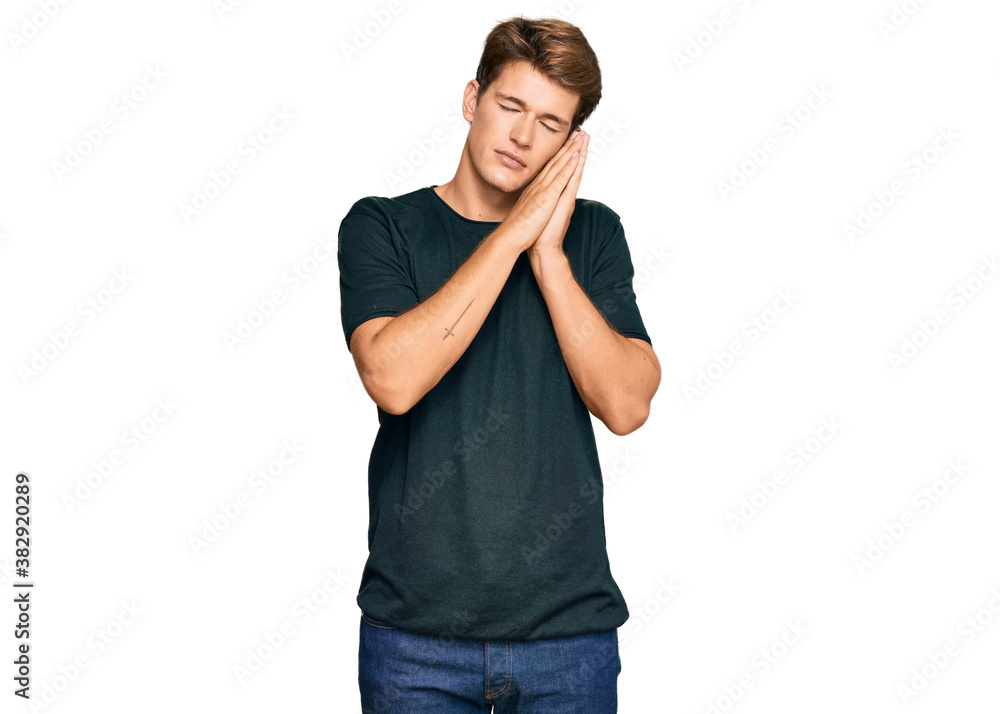 Handsome caucasian man wearing casual clothes sleeping tired dreaming and posing with hands together while smiling with closed eyes. Handsome caucasian man wearing casual clothes sleeping tired dreaming and posing with hands together while smiling with closed eyes.