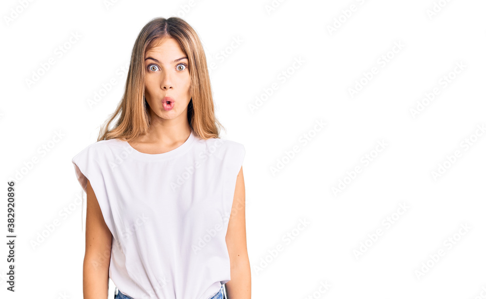 Beautiful caucasian woman with blonde hair wearing casual white tshirt afraid and shocked with surprise expression, fear and excited face. Beautiful caucasian woman with blonde hair wearing casual white tshirt afraid and shocked with surprise expression, fear and excited face.