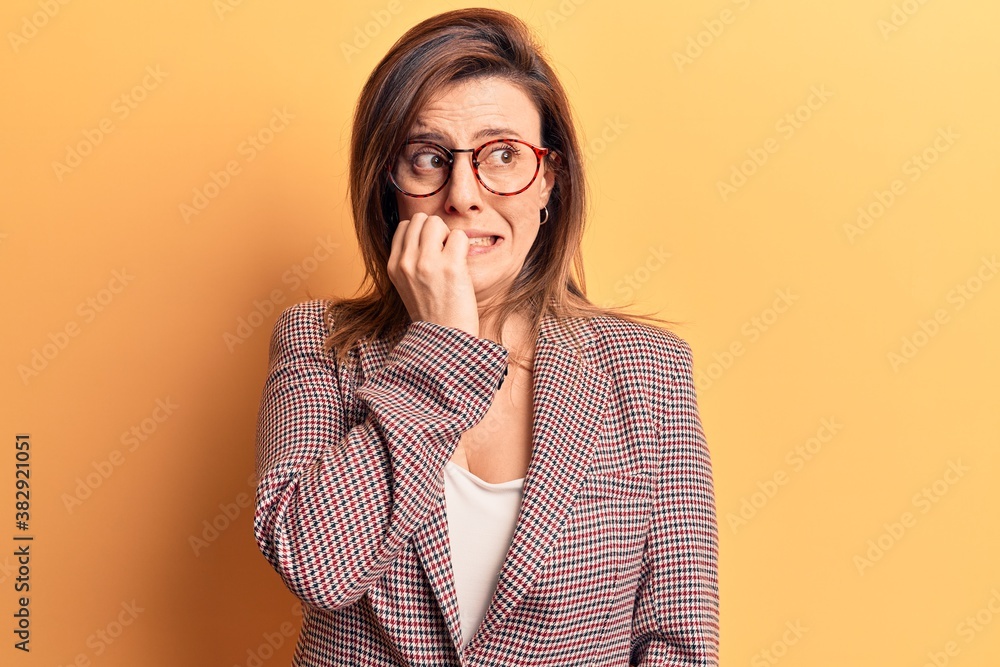Young beautiful woman wearing business clothes and glasses looking stressed and nervous with hands on mouth biting nails. anxiety problem. Young beautiful woman wearing business clothes and glasses looking stressed and nervous with hands on mouth biting nails. anxiety problem.