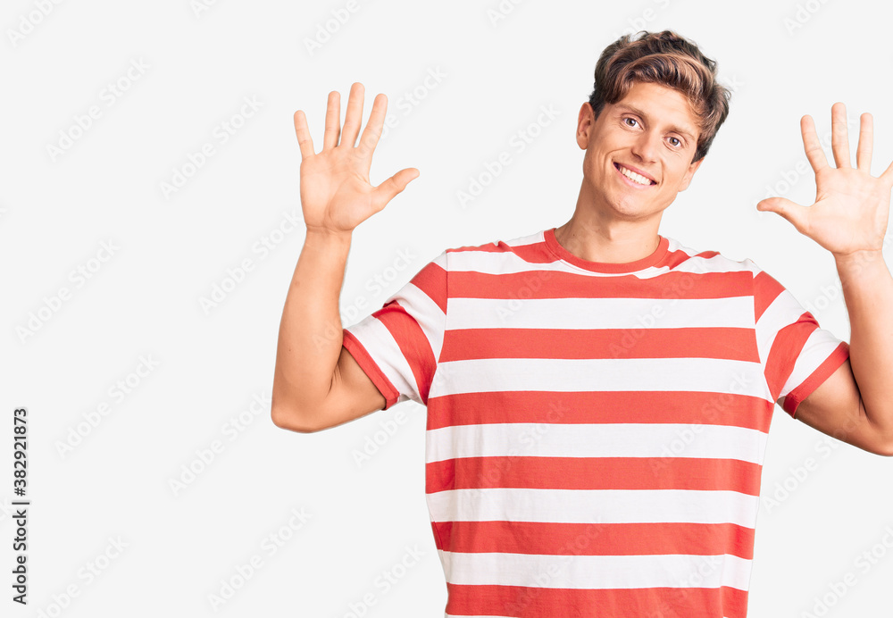 Young handsome man wearing casual clothes showing and pointing up with fingers number ten while smiling confident and happy. Young handsome man wearing casual clothes showing and pointing up with fingers number ten while smiling confident and happy.