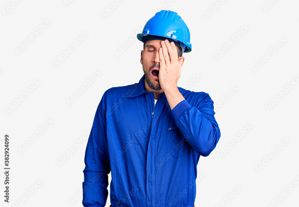 Young handsome man wearing worker uniform and hardhat begging and praying with hands together with hope expression on face very emotional and worried. begging. Young handsome man wearing worker uniform and hardhat begging and praying with hands together with hope expression on face very emotional and worried. begging.