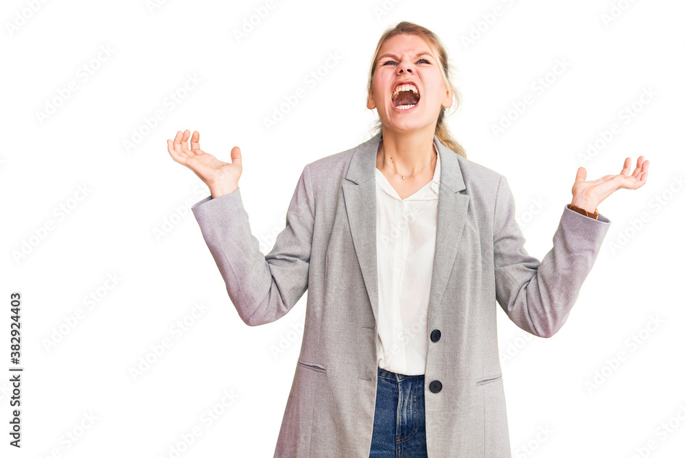 Young beautiful blonde woman wearing elegant jacket crazy and mad shouting and yelling with aggressive expression and arms raised. frustration concept. Young beautiful blonde woman wearing elegant jacket crazy and mad shouting and yelling with aggressive expression and arms raised. frustration concept.