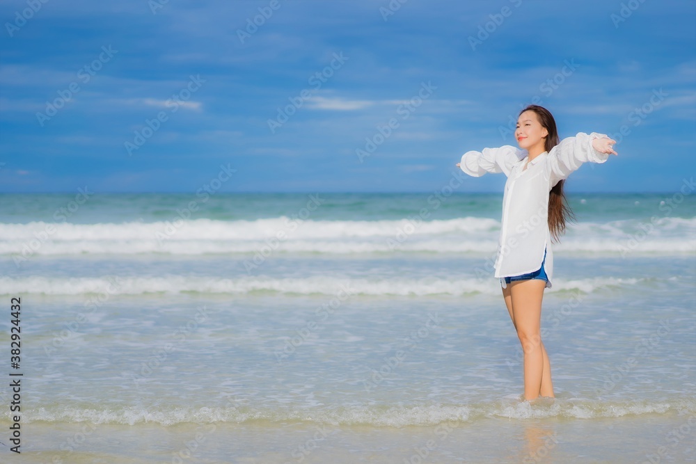 Portrait beautiful young asian woman relax smile around beach sea ocean