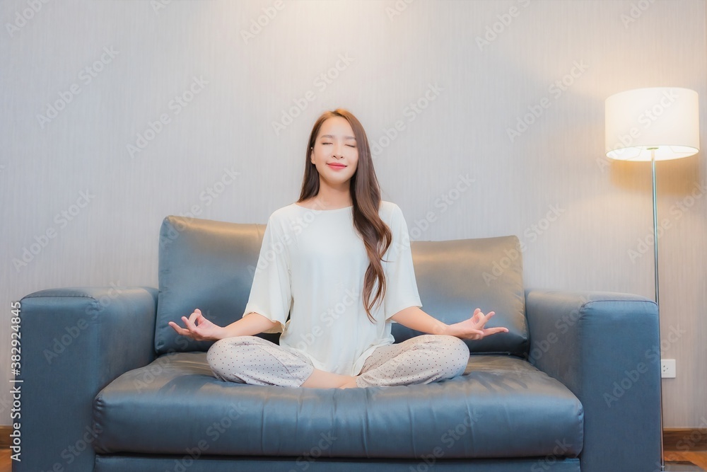Portrait beautiful young asian woman meditation on sofa