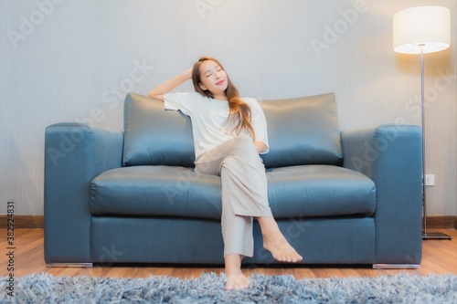 Portrait beautiful young asian woman relax on sofa in living room