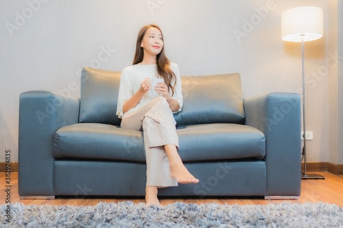 Portrait beautiful young asian woman relax on sofa in living room