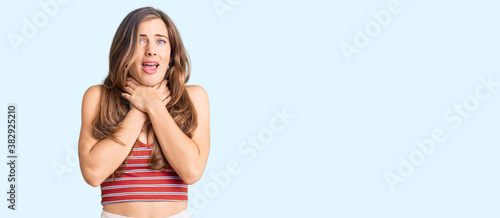 Beautiful caucasian young woman wearing casual clothes shouting and suffocate because painful strangle. health problem. asphyxiate and suicide concept.