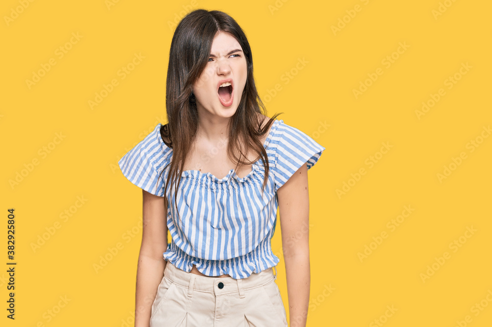 Young beautiful caucasian girl wearing casual clothes angry and mad screaming frustrated and furious, shouting with anger. rage and aggressive concept. Young beautiful caucasian girl wearing casual clothes angry and mad screaming frustrated and furious, shouting with anger. rage and aggressive concept.