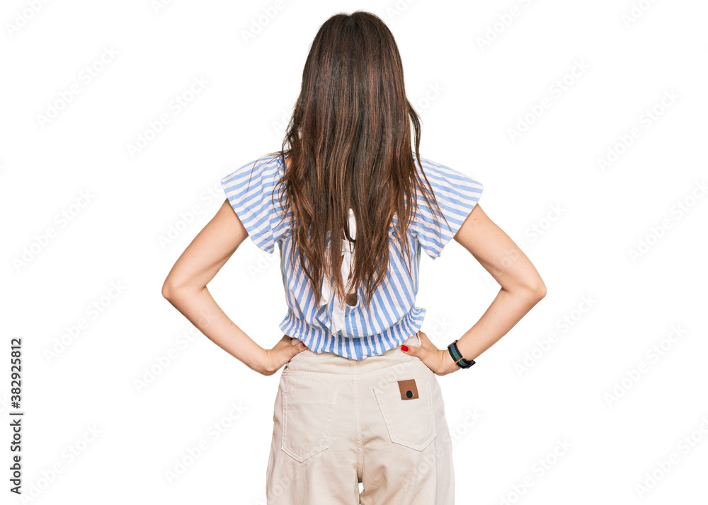 Young beautiful caucasian girl wearing casual clothes standing backwards looking away with arms on body