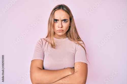 Young beautiful blonde woman wearing casual clothes skeptic and nervous, disapproving expression on face with crossed arms. negative person.