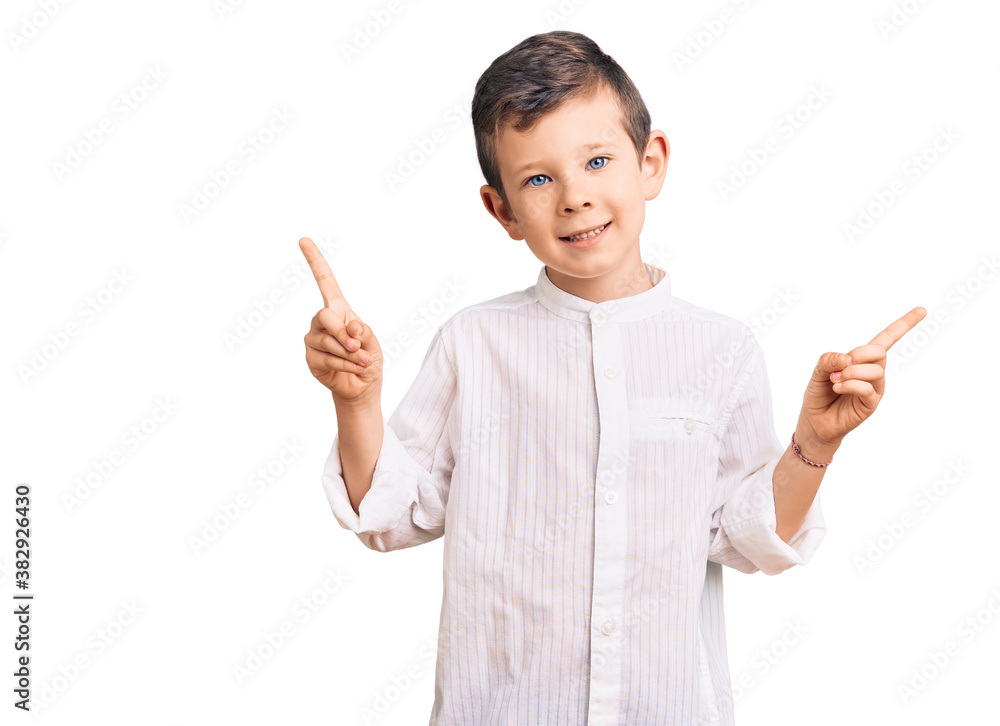 Cute blond kid wearing elegant shirt smiling confident pointing with fingers to different directions. copy space for advertisement Cute blond kid wearing elegant shirt smiling confident pointing with fingers to different directions. copy space for advertisement