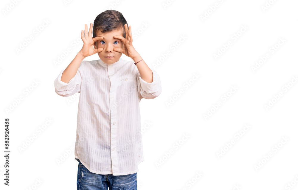 Cute blond kid wearing elegant shirt trying to open eyes with fingers, sleepy and tired for morning fatigue Cute blond kid wearing elegant shirt trying to open eyes with fingers, sleepy and tired for morning fatigue