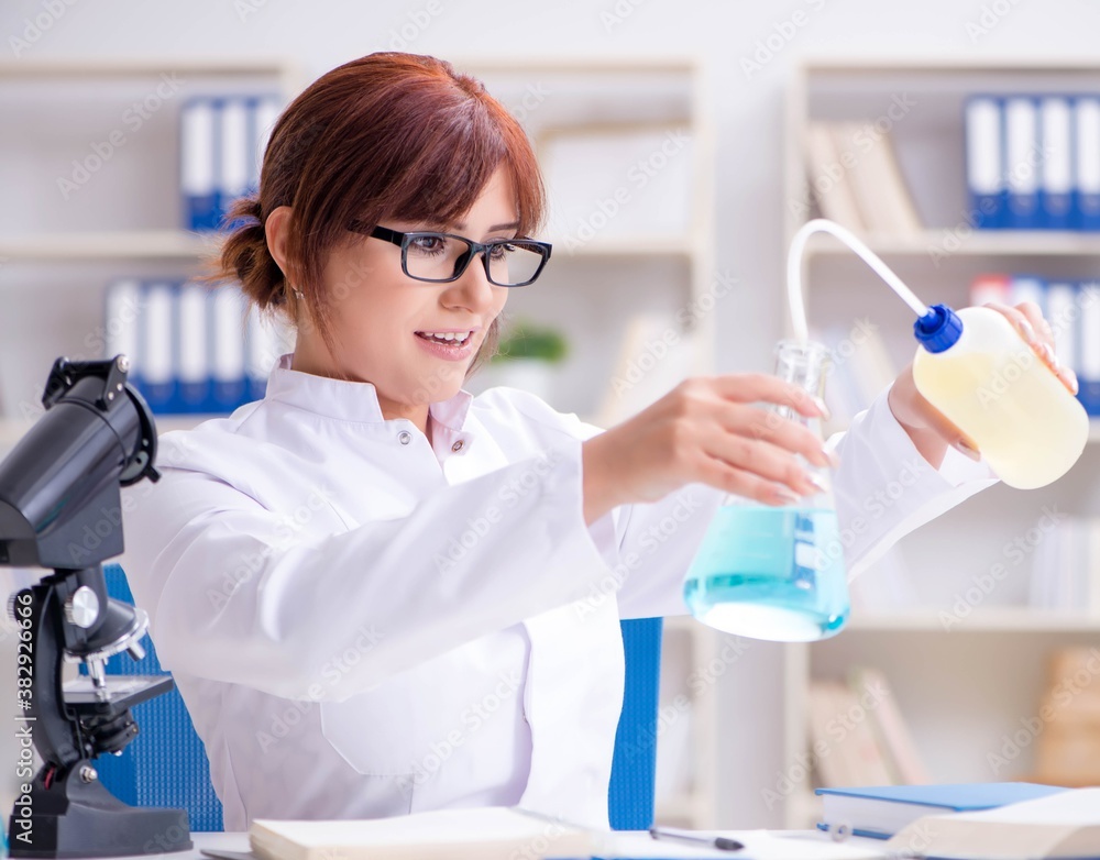 Female scientist researcher conducting an experiment in a labora Female scientist researcher conducting an experiment in a labora