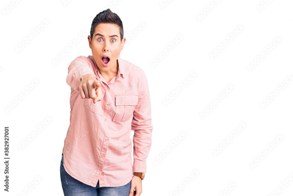 Young woman with short hair wearing casual clothes pointing displeased and frustrated to the camera, angry and furious with you Young woman with short hair wearing casual clothes pointing displeased and frustrated to the camera, angry and furious with you