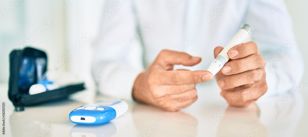 Close up of man with diabetes using insuline stick with syringe Close up of man with diabetes using insuline stick with syringe
