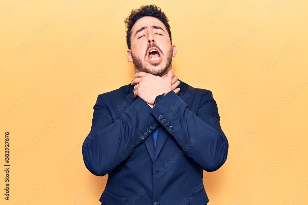 Fototapeta premium Young hispanic man wearing suit shouting and suffocate because painful strangle. health problem. asphyxiate and suicide concept.