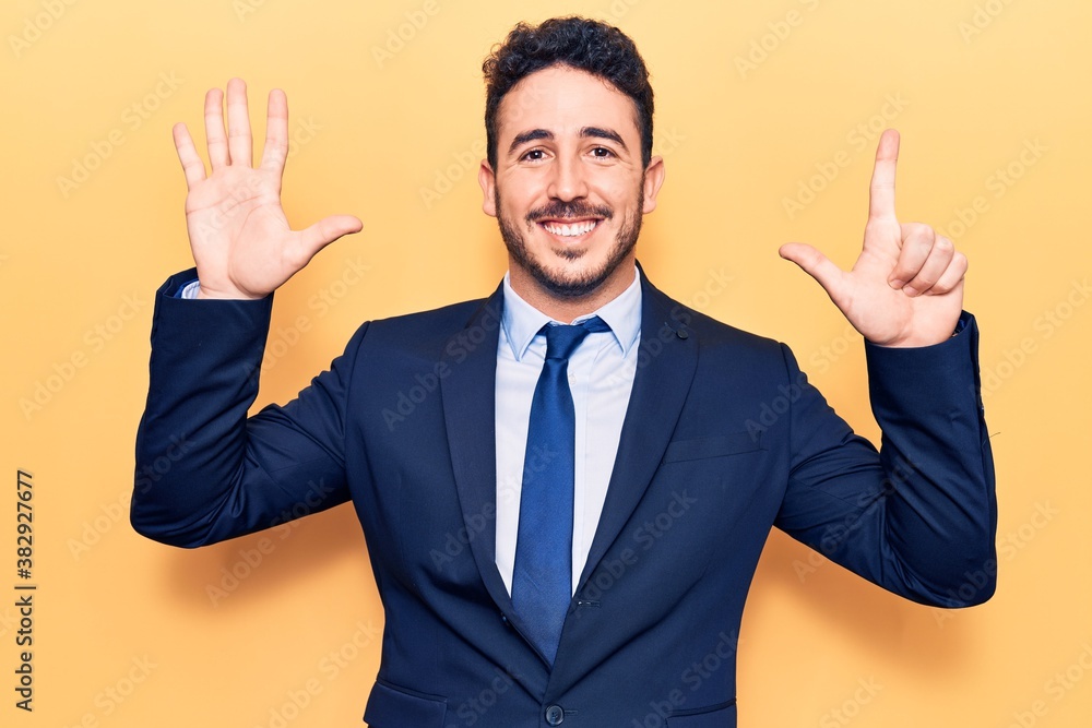 Young hispanic man wearing suit showing and pointing up with fingers number seven while smiling confident and happy. Young hispanic man wearing suit showing and pointing up with fingers number seven while smiling confident and happy.