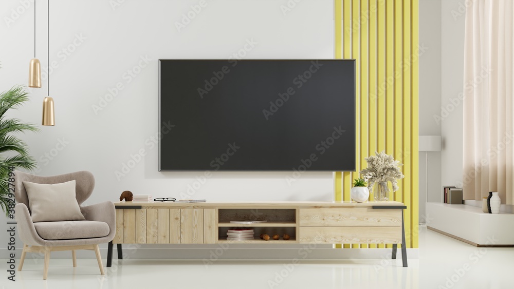 TV on cabinet in modern living room with armchair,lamp,table,flower and plant on white wall background.