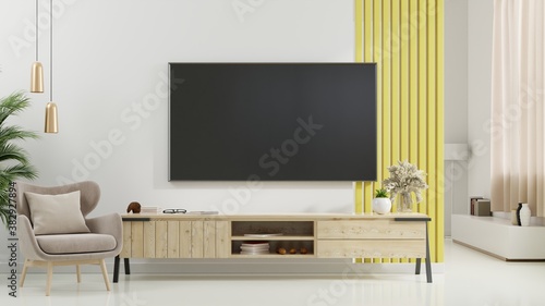 TV on cabinet in modern living room with armchair,lamp,table,flower and plant on white wall background.