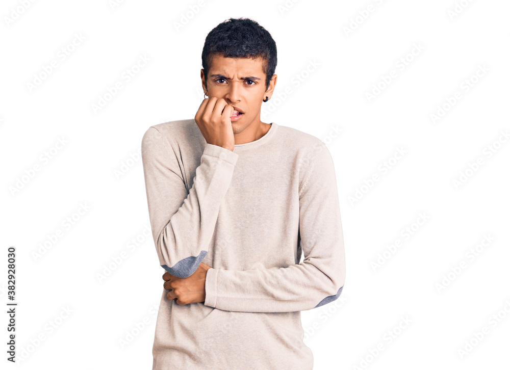 Young african amercian man wearing casual clothes looking stressed and nervous with hands on mouth biting nails. anxiety problem. Young african amercian man wearing casual clothes looking stressed and nervous with hands on mouth biting nails. anxiety problem.