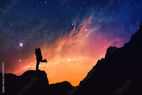 Silhouette of a Couple kissing on a starry night