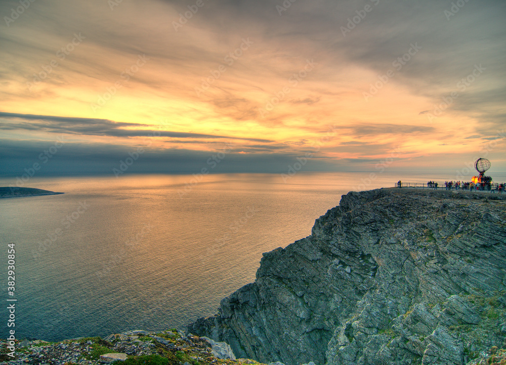 Sunset At North Cape In Norway On A Sunny Summer Day At Dusk With Only A Few Clouds In The Sky Sunset At North Cape In Norway On A Sunny Summer Day At Dusk With Only A Few Clouds In The Sky