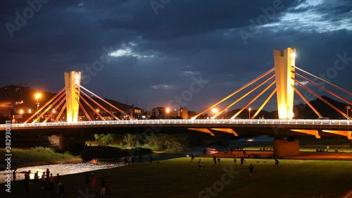 Modern impressive design of cable-stayed bridge of Can Peixauet over Besos connecting Barcelona with Santa Coloma de Gramanet at night, Spain photo