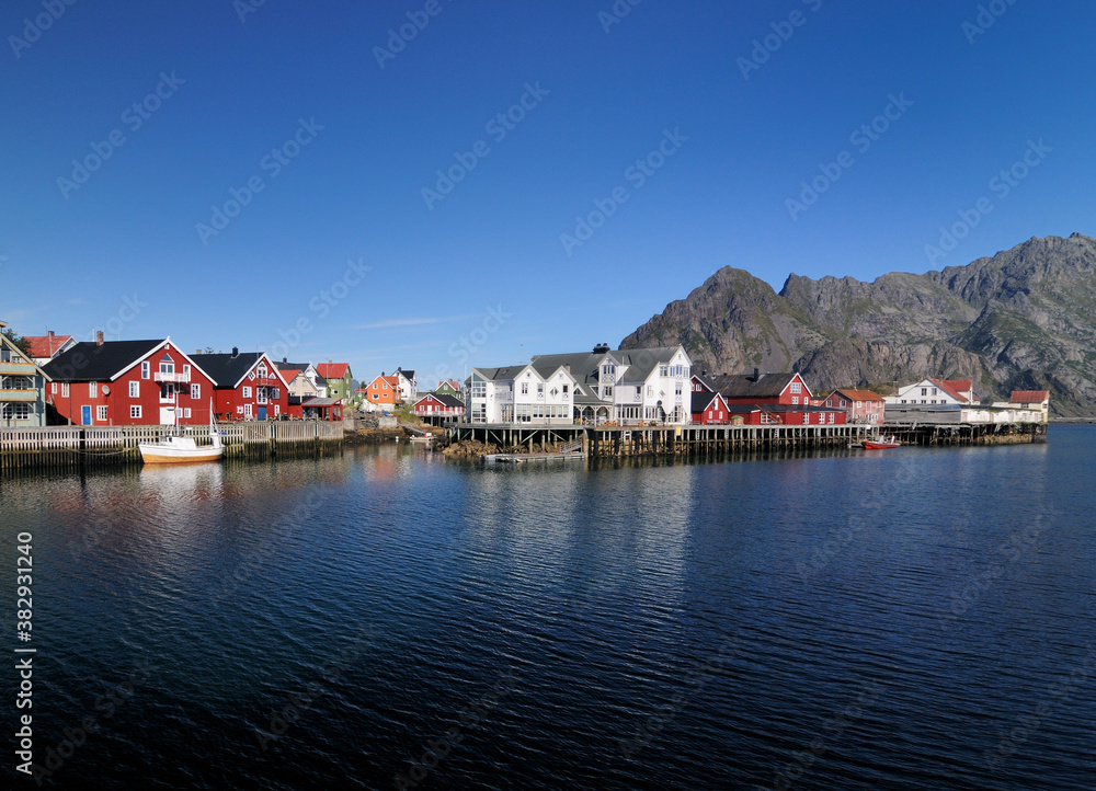 Waterfront Of the Small Fishing Village Henningsvaer On Lofoten Island Austvagoy On A Sunny Summer Day With A Clear Blue Sky