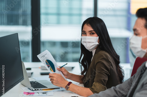 Asian business people wear face mask new normal in office meeting room