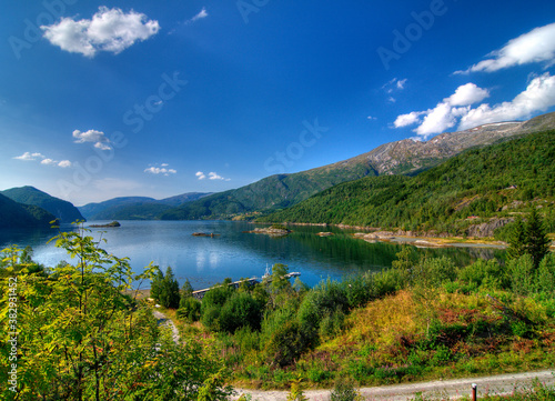 View To Leirfjord At Baggfossen Falls On A Sunny Summer Day With A Clear Blue Sky And A Few Clouds