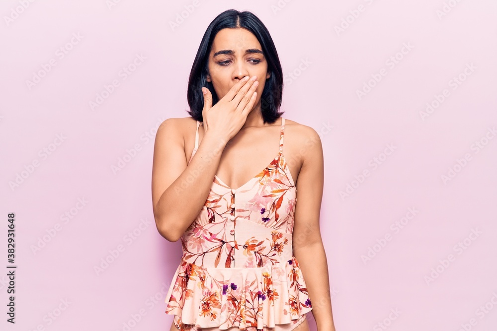 Young beautiful latin woman wearing casual clothes bored yawning tired covering mouth with hand. restless and sleepiness. Young beautiful latin woman wearing casual clothes bored yawning tired covering mouth with hand. restless and sleepiness.