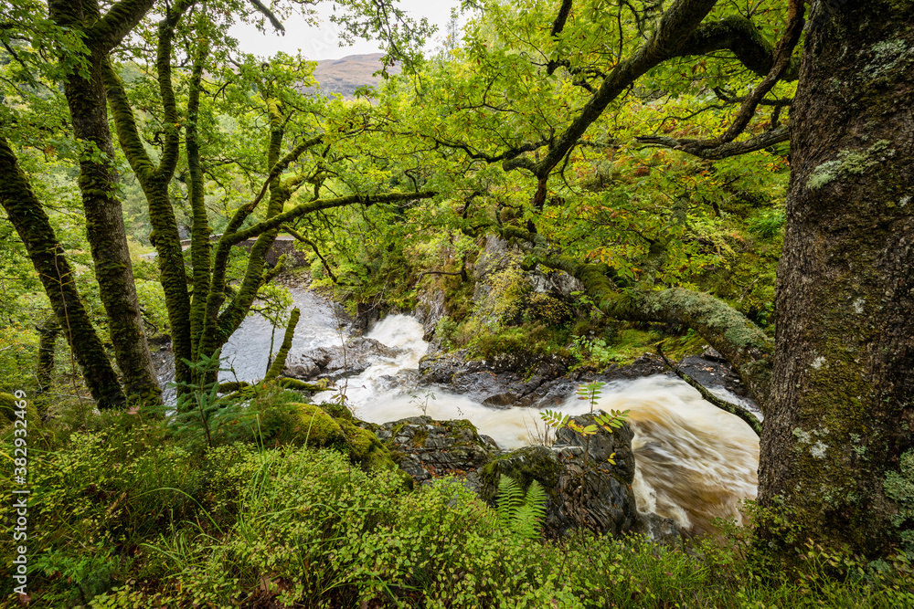 shot of Eas Chia-Aig waterfalls in Glen Chia-Aig near Achnacarry, Gairlochy and Fort William in the argyll region of the highlands of Scotland during autumn after heavy rainfall