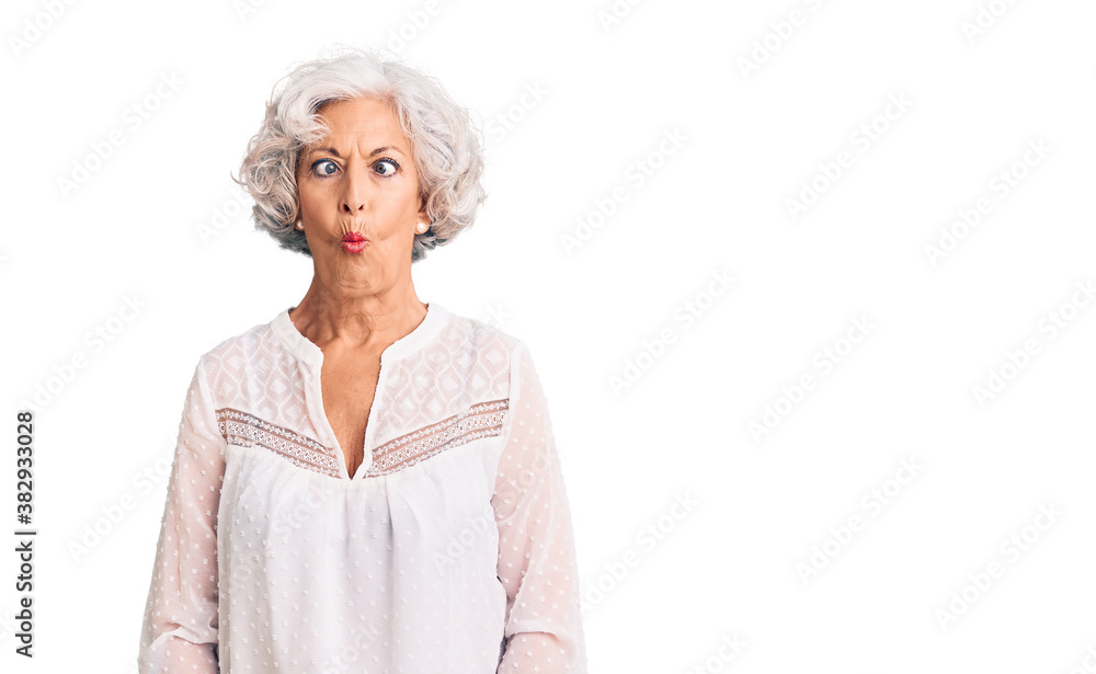 Senior grey-haired woman wearing casual clothes making fish face with lips, crazy and comical gesture. funny expression. Senior grey-haired woman wearing casual clothes making fish face with lips, crazy and comical gesture. funny expression.