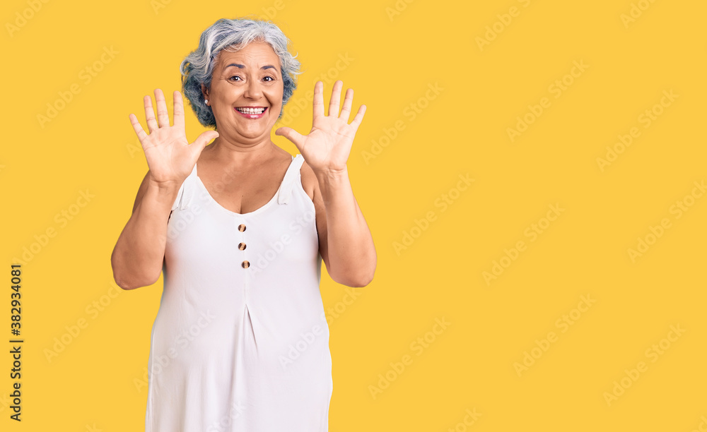 Senior woman with gray hair wearing casual clothes showing and pointing up with fingers number ten while smiling confident and happy.