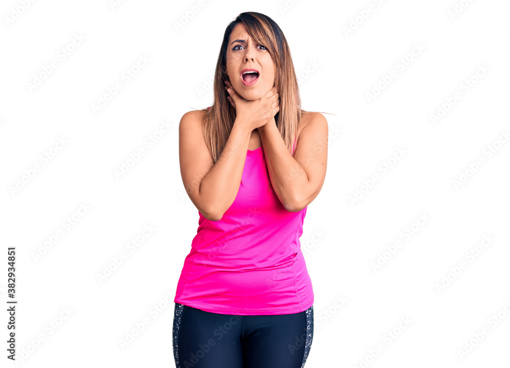 Young beautiful woman wearing sportswear shouting and suffocate because painful strangle. health problem. asphyxiate and suicide concept. Young beautiful woman wearing sportswear shouting and suffocate because painful strangle. health problem. asphyxiate and suicide concept.