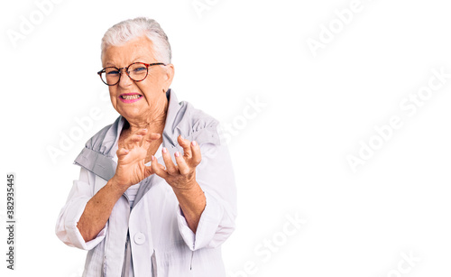 Senior beautiful woman with blue eyes and grey hair wearing casual clothes and glasses disgusted expression, displeased and fearful doing disgust face because aversion reaction. with hands raised © Krakenimages.com