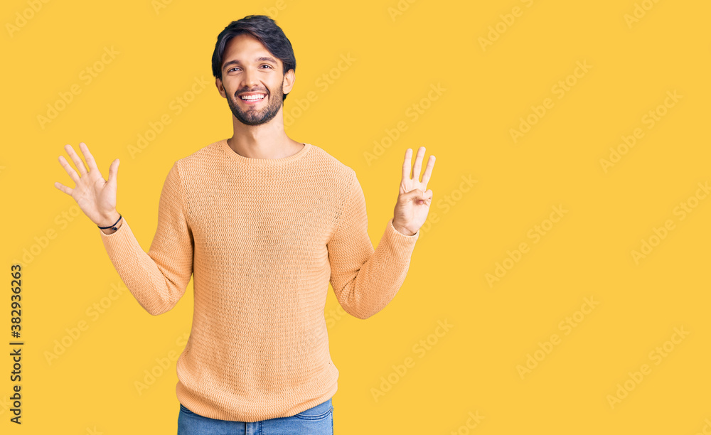 Handsome hispanic man wearing casual sweater showing and pointing up with fingers number eight while smiling confident and happy. Handsome hispanic man wearing casual sweater showing and pointing up with fingers number eight while smiling confident and happy.