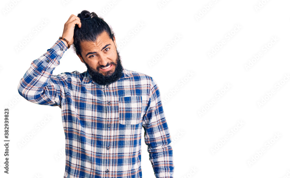 Young arab man wearing casual clothes confuse and wonder about question. uncertain with doubt, thinking with hand on head. pensive concept. Young arab man wearing casual clothes confuse and wonder about question. uncertain with doubt, thinking with hand on head. pensive concept.