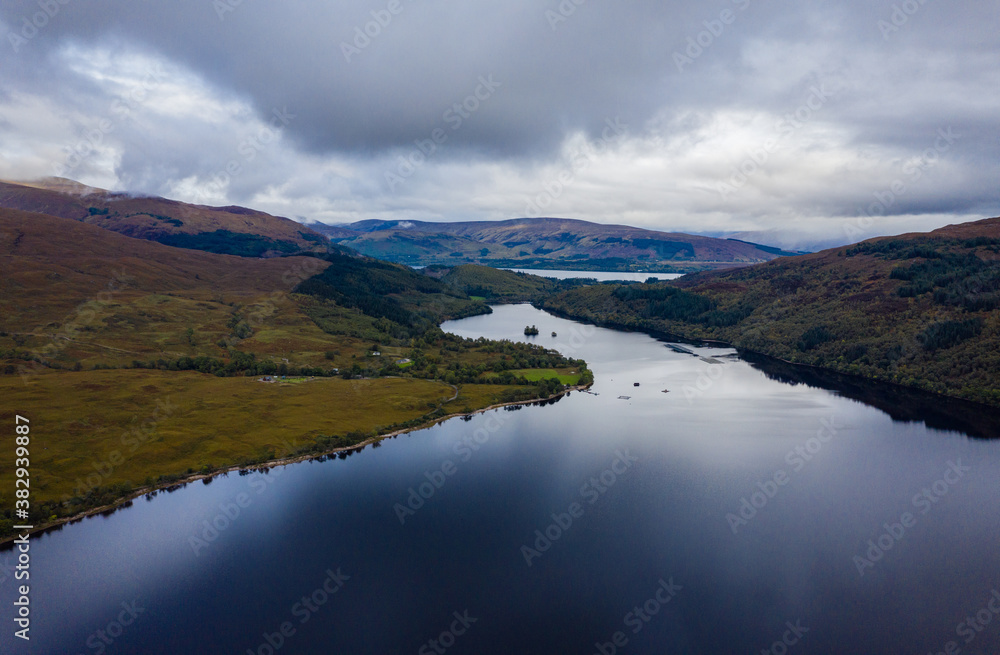 shot of loch arkaig in the argyll region of the highlands of scotland during autumn on a clear bright day showing calm waters on the inland loch