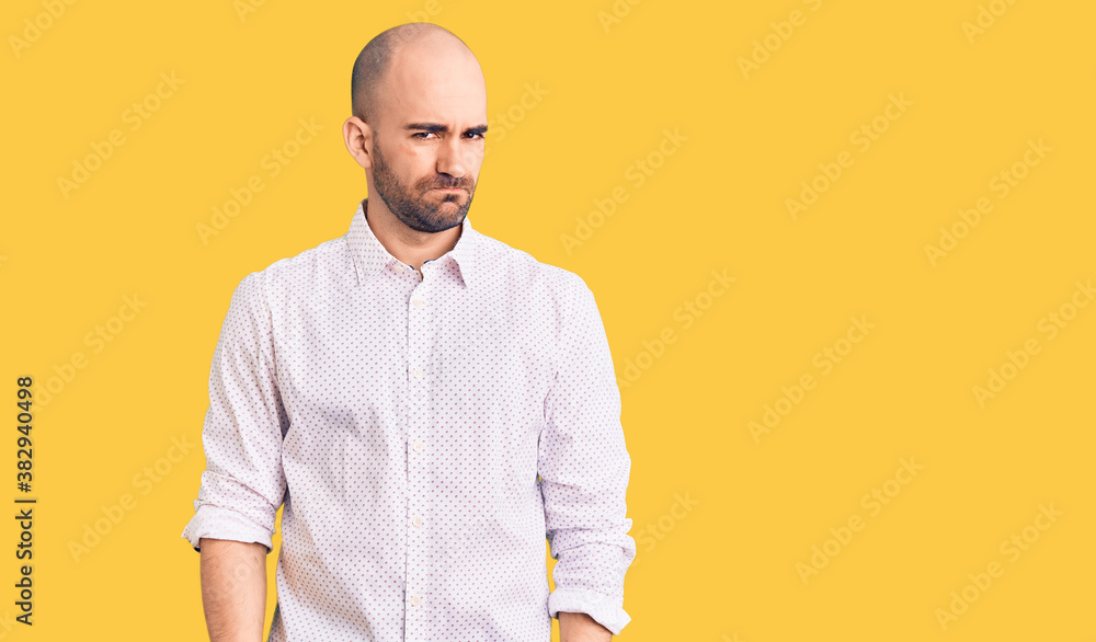 Young handsome man wearing elegant shirt skeptic and nervous, frowning upset because of problem. negative person. Young handsome man wearing elegant shirt skeptic and nervous, frowning upset because of problem. negative person.